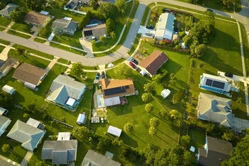 Aerial view of small town America suburban landscape with private homes between green palm trees in...