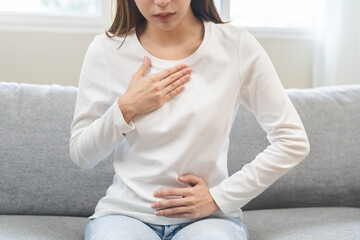 Acid reflux disease, suffer asian young woman have symptom gastroesophageal, esophageal, stomach...