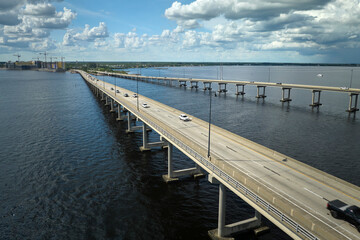 Fototapeta na wymiar Barron Collier Bridge and Gilchrist Bridge in Florida with moving traffic. Transportation infrastructure in Charlotte County connecting Punta Gorda and Port Charlotte over Peace River