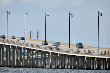 Barron Collier Bridge and Gilchrist Bridge in Florida with moving traffic. Transportation infrastructure in Charlotte County connecting Punta Gorda and Port Charlotte over Peace River
