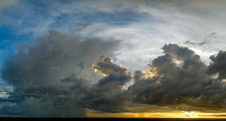 Cumulonimbus clouds forming before thunderstorm on evening sky. Changing stormy cloudscape weather...