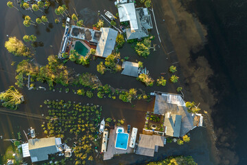 Heavy flood with high water surrounding residential houses after hurricane Ian rainfall in Florida residential area. Consequences of natural disaster