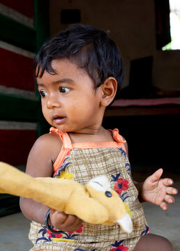 girl child playing with toy, portrait image
