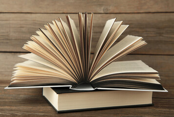 Open book on grey wooden background. Space for text