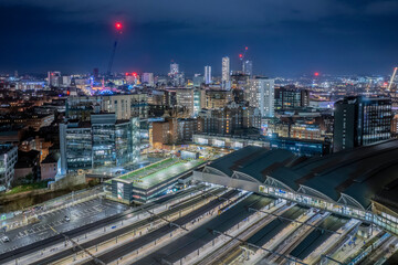Leeds train station, West Yorkshire city centre aerial view. railway transport links. Illuminated at night view overlooking the city