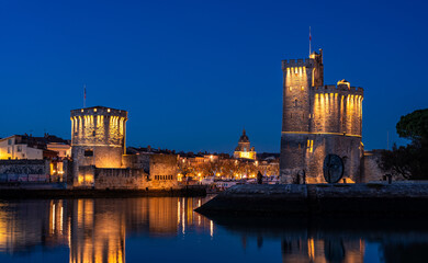 beautiful illuminated cityscape of the old harbor of La Rochelle