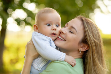 Happy mom and cute smiling baby boy. Positive human emotions, feelings, natural lifestyles. Family background.