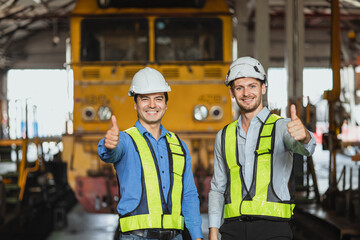 engineer male team staff worker happy smile work in locomotive depot train yard transportation...