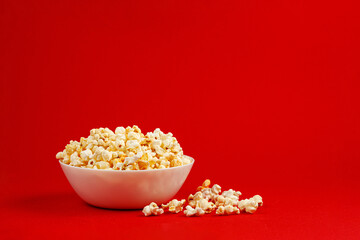 plate with popcorn on a red background