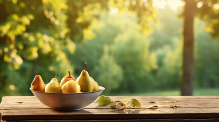  a bowl full of pears sitting on a wooden table in front of a green forest with sunlight shining on the leaves and trees in the backgroup. - obrazy, fototapety, plakaty