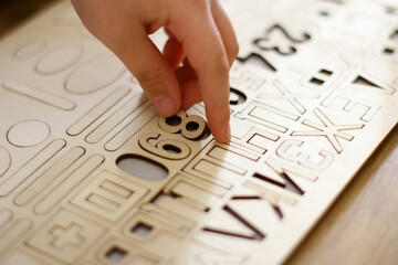 the child plays with numbers and letters of the alphabet. Intellectual game, preschool education