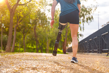 Close-up of a disabled man with prosthetic leg running outdoors
