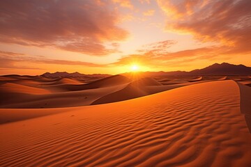  the sun is setting over a desert with sand dunes in the foreground and a mountain range in the distance in the distance, with a few clouds in the sky.