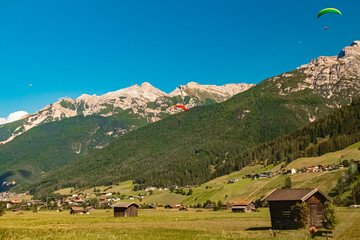Alpine summer view with paragliders near Neustift, Stubaital valley, Innsbruck, Tyrol, Austria
