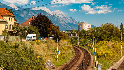 Alpine summer view with railway tracks and the famous Nordkette mountains in the background at...