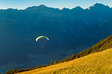 Alpine summer view with a paraglider at Mount Kreuzjoch, Fulpmes, Stubaital valley, Innsbruck,...