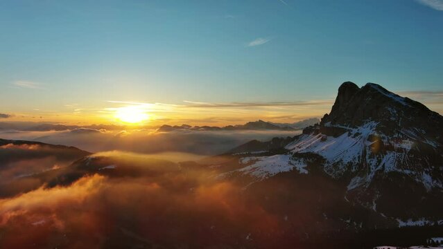 Aerial view of amazing rocky mountains in snow and sunrise sun, Dolomites, Italy, 4k