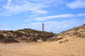 Faro de Trafalgar, view over the dunes to the lighthouse at a sandy headland between Los Caños de...