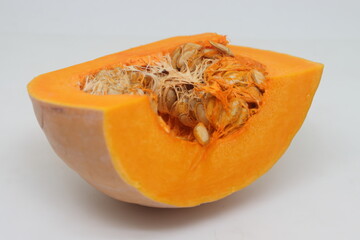 whole and half butternut squash isolated on white background. Slices of pumpkin on a white background, close-up.
