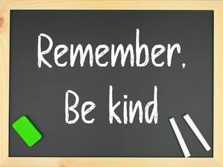 Blackboard with the words remember: be kind written in white with two chalks and a green eraser