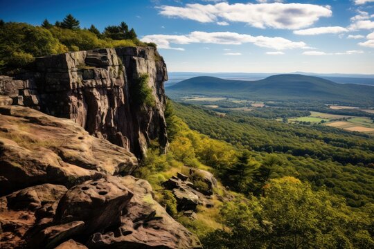  the view from the top of a mountain looking down on a valley and mountains in the distance with a blue sky with white clouds and wispy wispy wispy wispy wispy wispy wispy wispy wispy wispy.