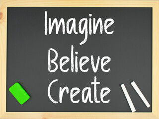Blackboard with the words Imagine, believe create written in white with two chalks and a green eraser
