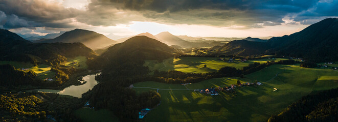 Dramatic Sunset Over a Charming Alpine Village and Church in the Austrian Alps