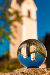 Crystal ball alpine summer landscape shot at the famous Maria Waldrast monastery, Matrei am...