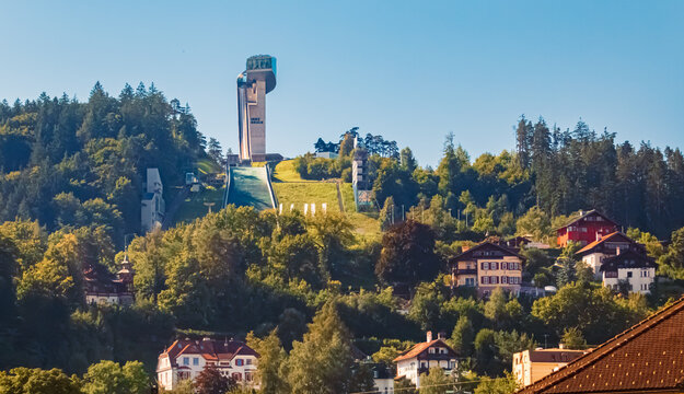 Alpine summer view with the famous Berg Isel Ski Jump Tower in the background near Innsbruck, Austria