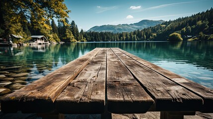 Empty wooden table top with a smooth, wooden deck that overlooks summer lakes and green forests.