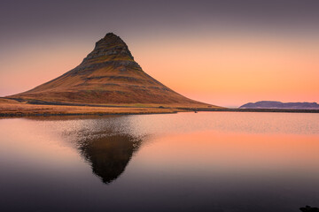 Amazing sunrise view of the Kirkjufell. Symmetric reflection over the lake,  Iceland