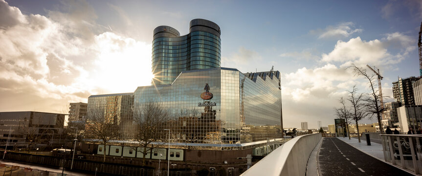 High rise buildings around central infrastructure train station hub with modern contemporary architecture of financial institution Rabobank at sunset