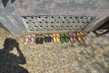 Shoes and slippers outside a mosque.