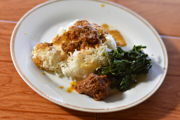 Nasi Padang with rendang is an Indonesian food from West Sumatra in Indonesia. Nasi Padang as favorites food for Indonesian people.

