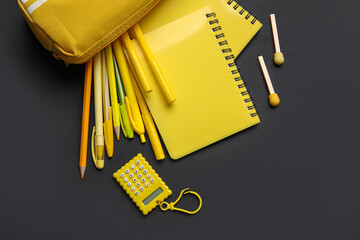 Pencil case with different school stationery on black background, closeup - Powered by Adobe