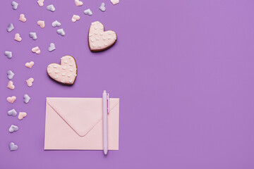 Heart shaped sweet cookies and envelope on purple background. Valentine's day celebration