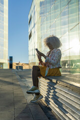Afro-american lady with smart-phone in urban environment