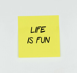 Yellow Post-it with the phrase llive is fun written in black, with a white background