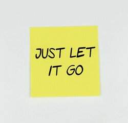 Yellow Post-it with the phrase Just let it go written in black, with a white background

