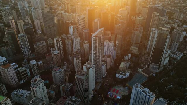 Aerial view of skyscrapers buildings in Makati business district and Manila city at sunset, capital of Philippines, 4k