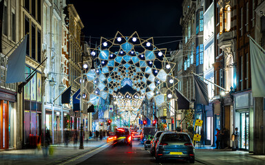 Fototapeta na wymiar Crowded New Bond street decorated for Christmas, London, England