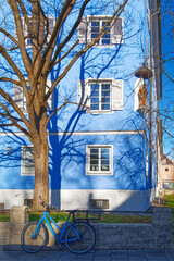 Blue bicycle in the front of a blue house