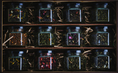 Set of various leaf tea packaged in jars. Black and green healthy tea with fruits, berries and herbs.