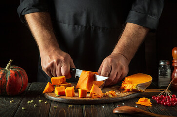 Cooking a national delicious pumpkin dish with the hands of a chef in a restaurant kitchen. Working...