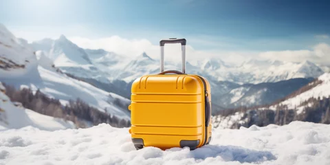 Foto op Canvas Hand luggage yellow plastic travel suitcase on the snow with snowy mountains on the background. Winter vacation and tourism poster concept. © OleksandrZastrozhnov