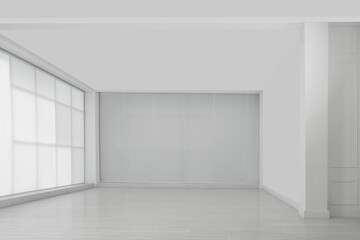 Empty room with white walls and laminated flooring
