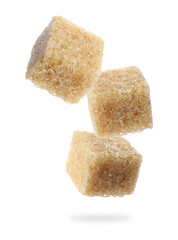 Cubes of brown sugar falling on white background