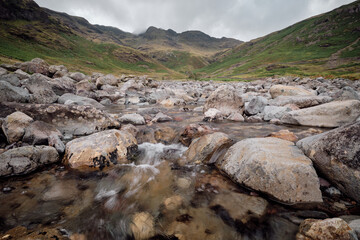 Down low by Oxednale Beck looking up to Crinkle Crags, Lake District, UK