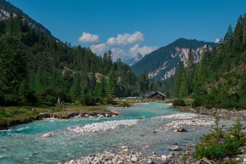 Turquoise river Isar flowing through the Karwendel mountains during sunny blue sky day in summer, Tyrol Austria. - 704096322
