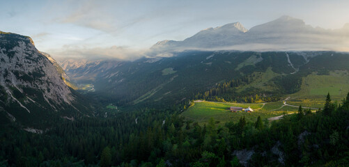 Panorama of the Karwendel refuge over the Karwendel valley in the mountains during morning in summer from above, Tyrol Austria. - 704096941